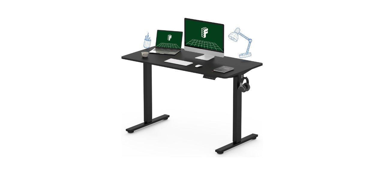 Flexispot Standing Desk with a computer and monitor on it and illustrations of desk lamps above it