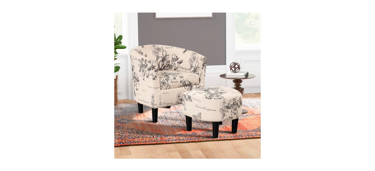 Ophelia & Co. Pamplona 26-Inch Upholstered Barrel Chair and Ottoman in beige with black floral designs and French words on them