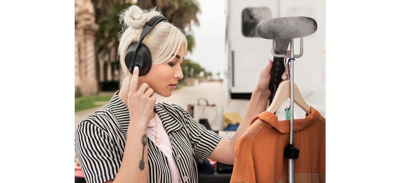 Woman wearing Bose Headphones 700 looking at blouse