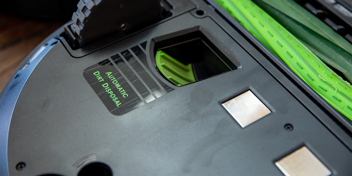 Underside of robot vacuum that shows charging contacts