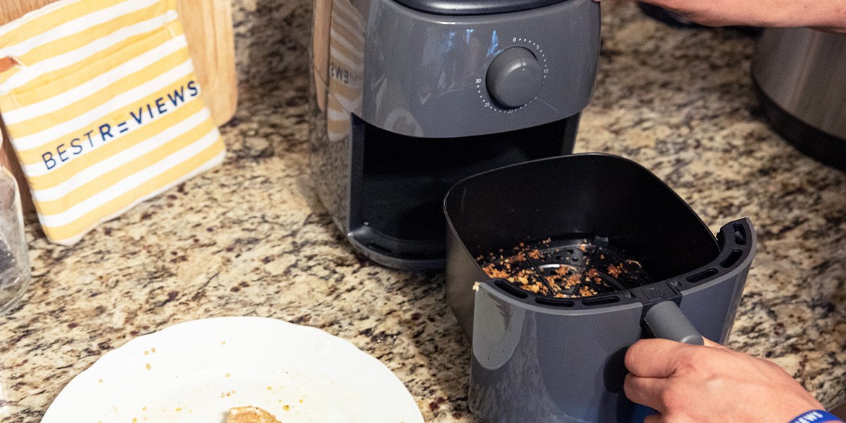 Person removing air fryer basket