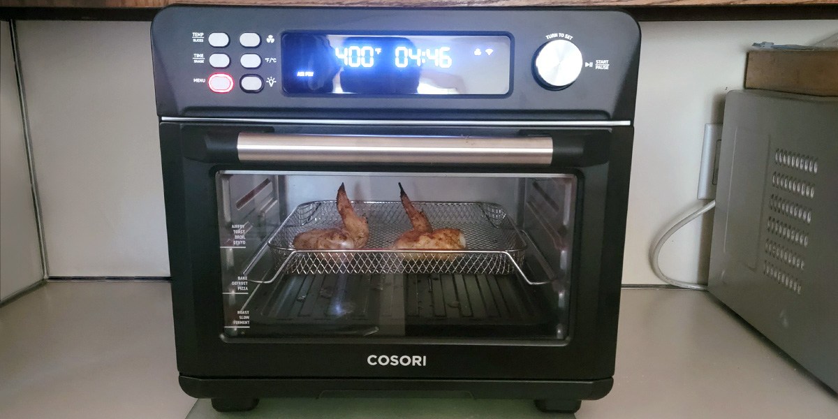 Cosori Smart Air Fryer to with chicken wings cooking inside