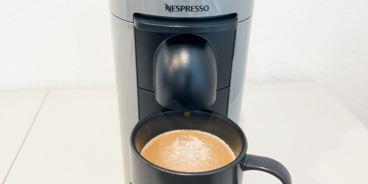 Nespresso machine with cup of coffee