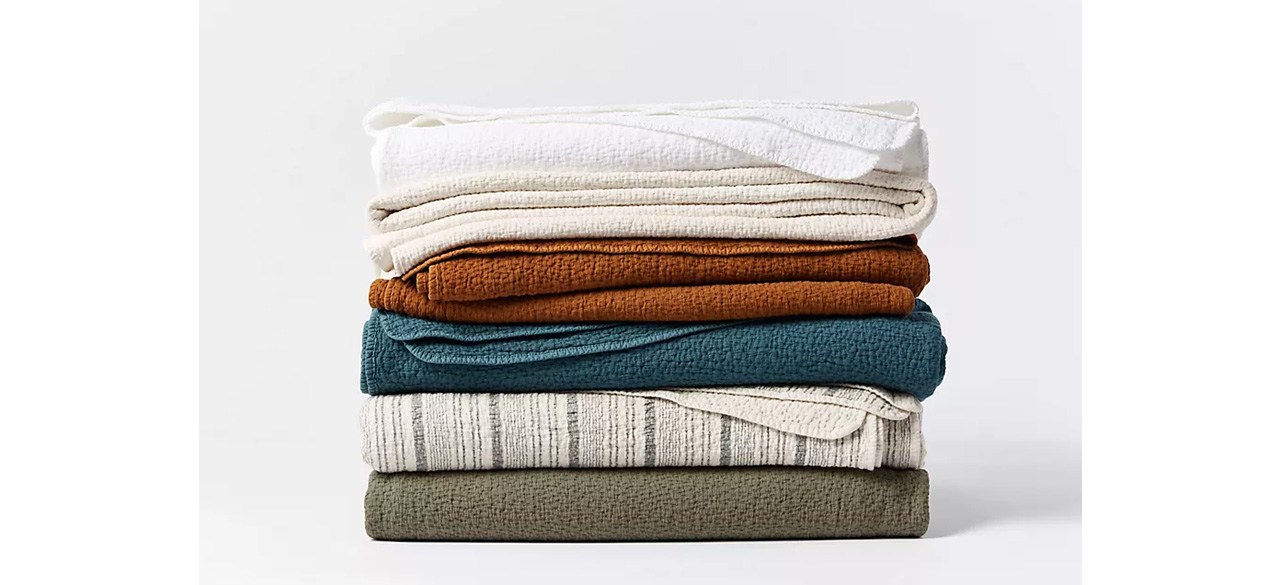 Coyuchi Cascade Organic Matelasse Blankets folded and stacked