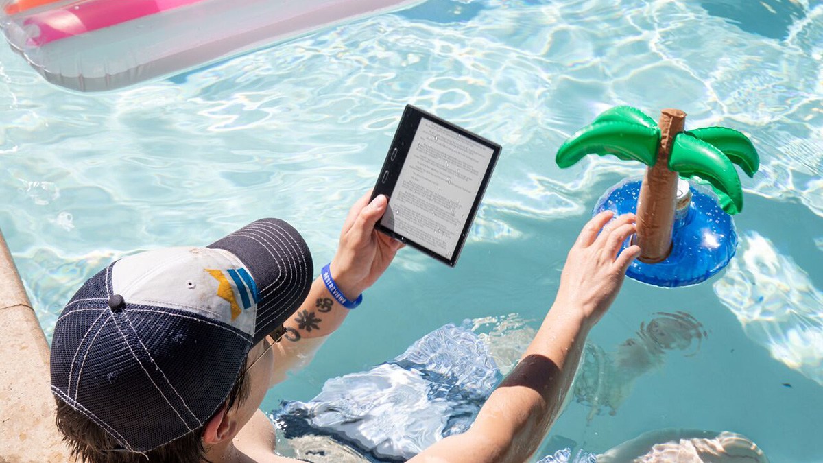 Person in pool using Kindle E-Reader