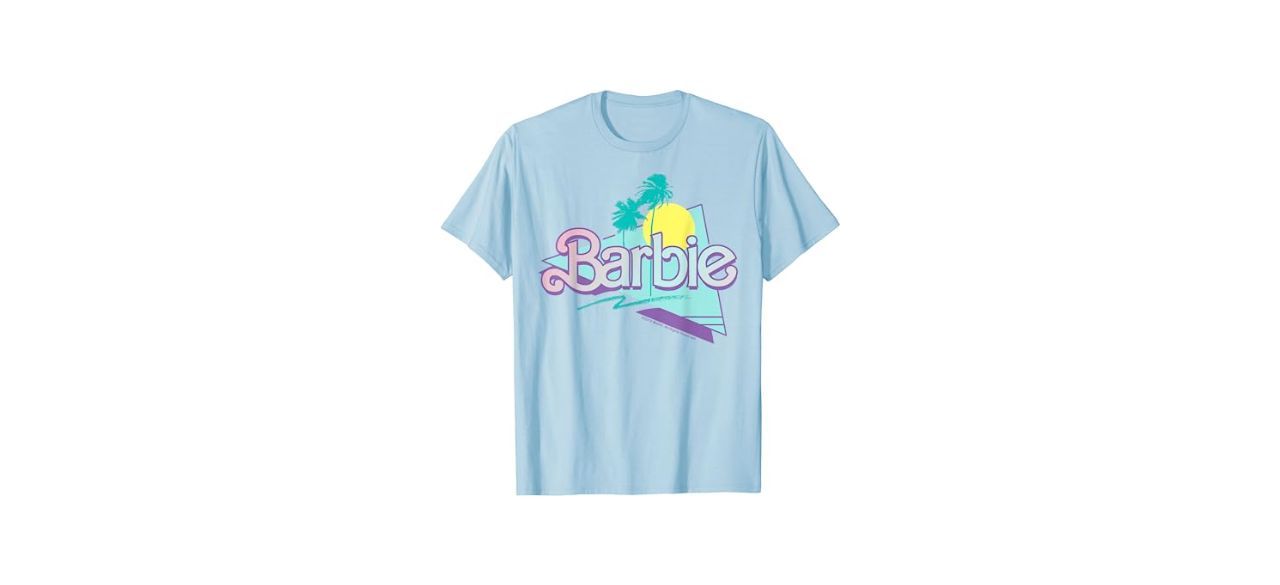 a light blue t-shirt with the Barbie logo on it and some palm trees