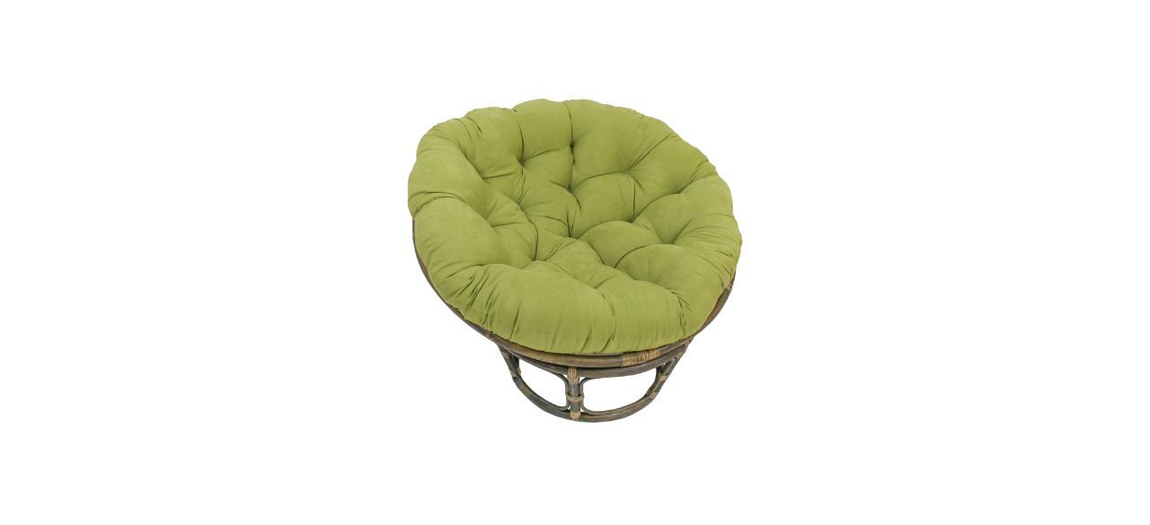 A round accent chair with a green cushion