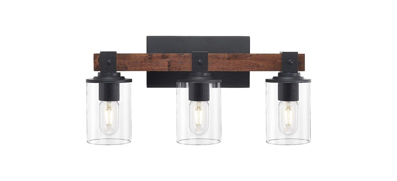 a light fixture with vintage looking light bulbs and matte black and wooden accents.