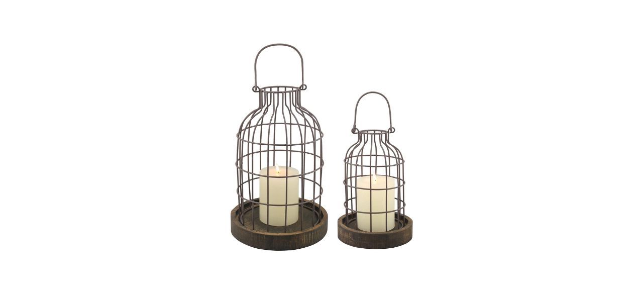 Two mini cage things with wood on the bottom. They have rounded tops and each hold one candle.