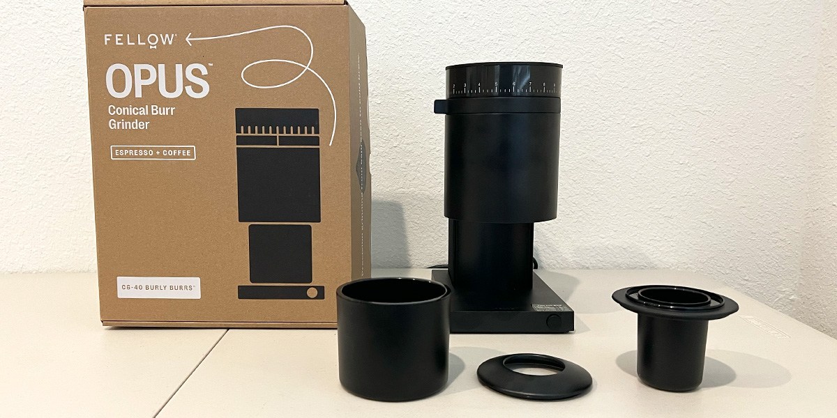 Fellow Opus Conical Burr Coffee Grinder next to product packaging on kitchen counter