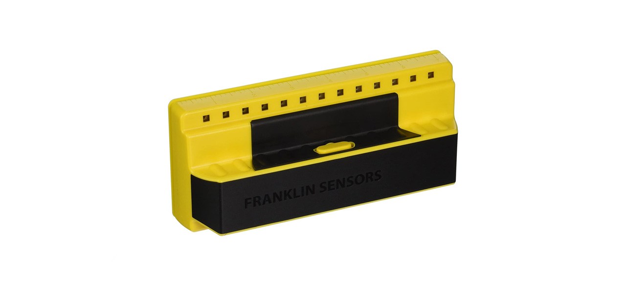 a yellow and black stud finder on a white background