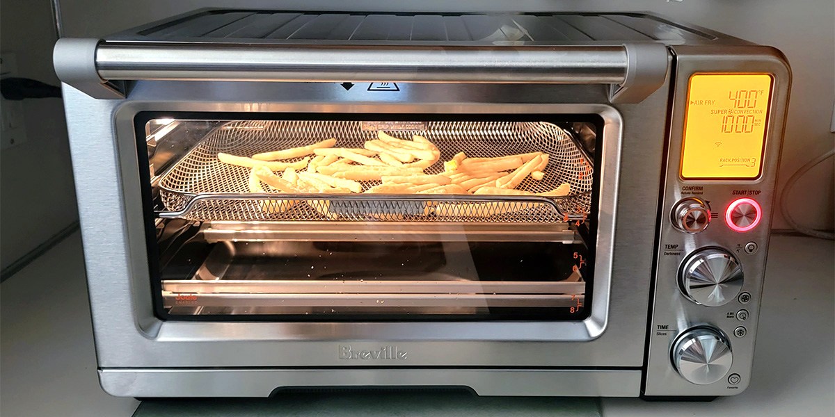 French fries cooking in air fryer with viewing window