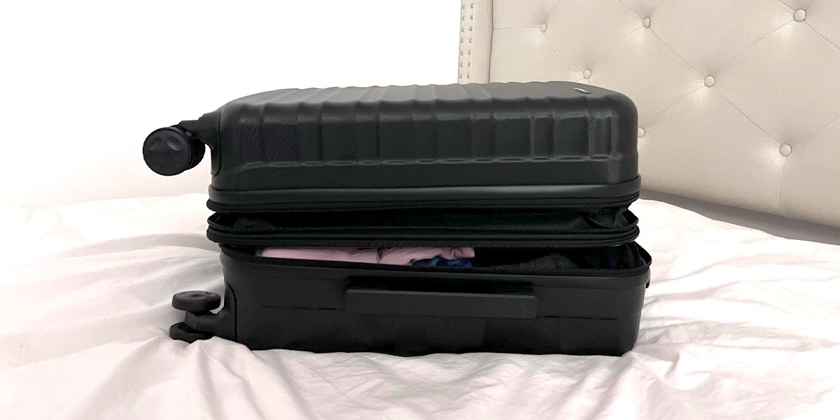 Hardside luggage on bed