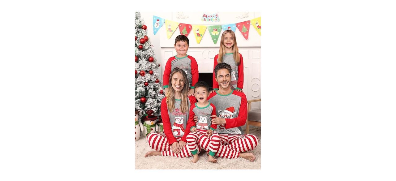 a family wearing Christmas pajamas with a polar bear on the shirt and red and white striped pants