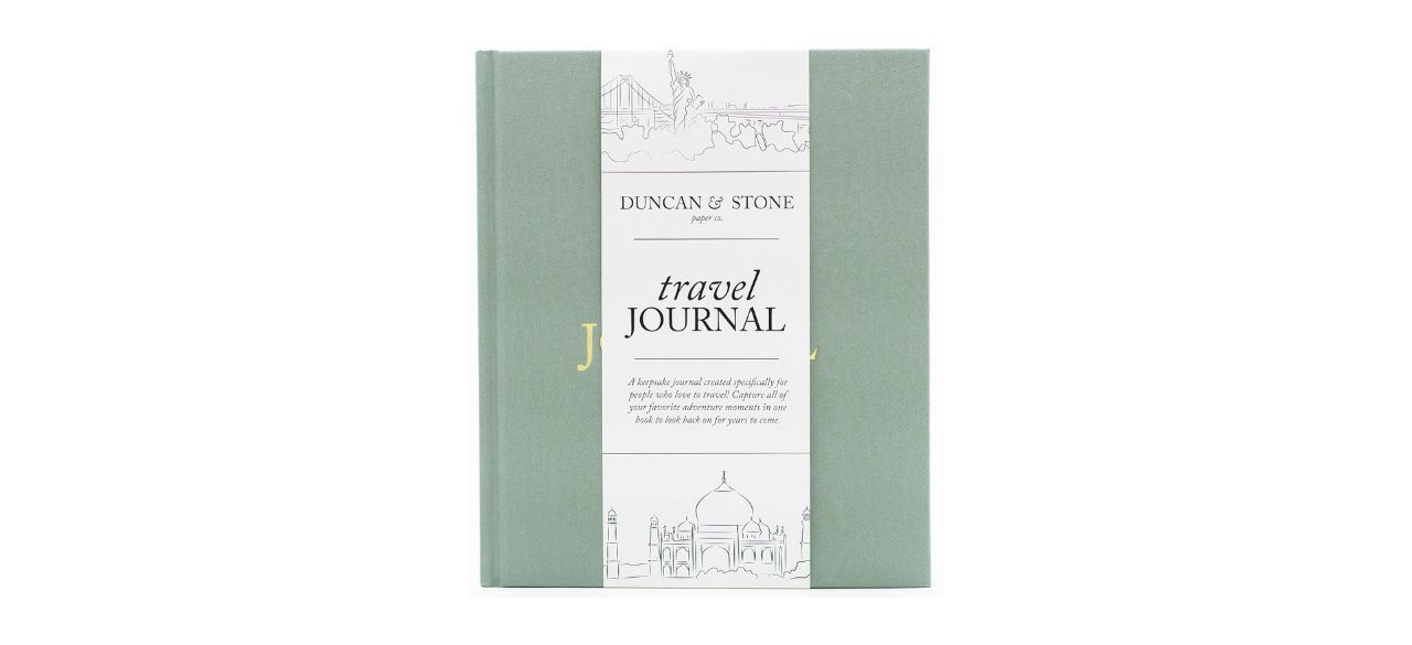 light green fabric-covered travel journal on white background