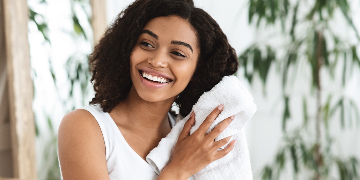 Woman blotting hair dry with towel