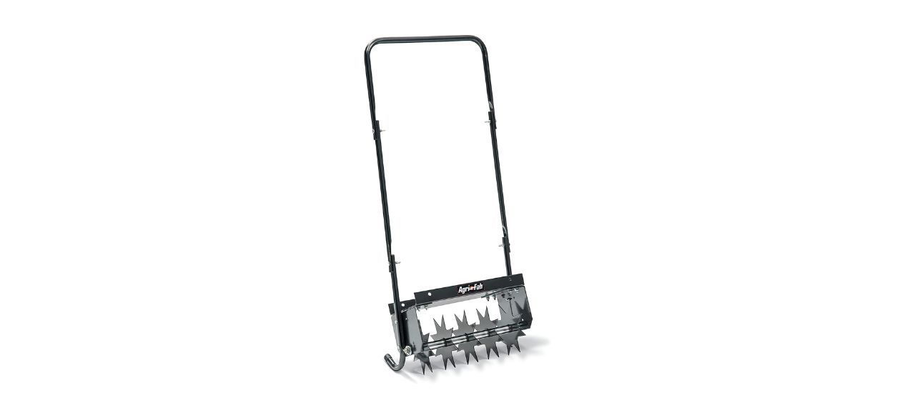 A manual push aerator that looks like a manual push lawnmower but with spiked wheels on it