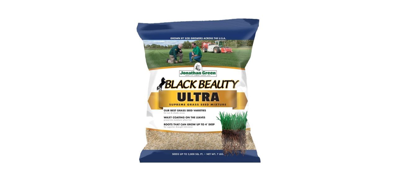 A blue and white bag of grass seed. Packaging indicates that it helps grass leaves have a protective waxy coating and help the roots grow up to 4 feet deep, 