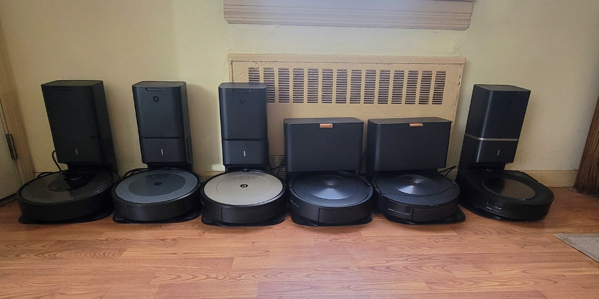 Several Roomba models next to each other charging