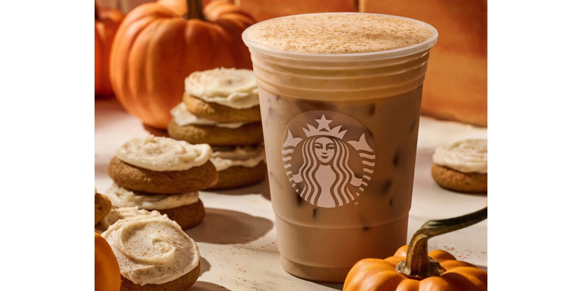 Starbucks Pumpkin Spice Latte next to cookies and pumpkin