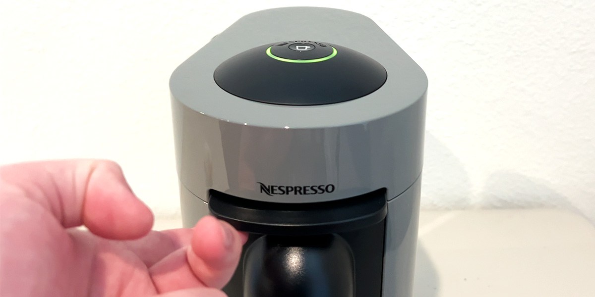 Person using Nespresso machine