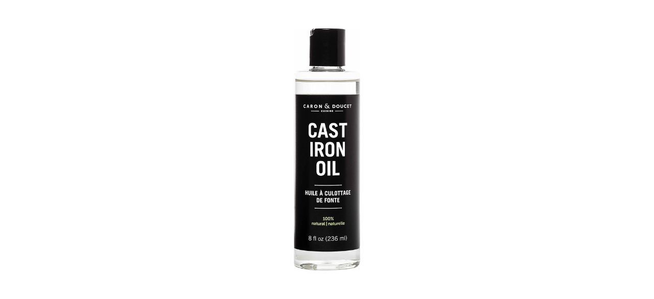 An 8-ounce clear bottle of cast iron oil with a black label and black cap