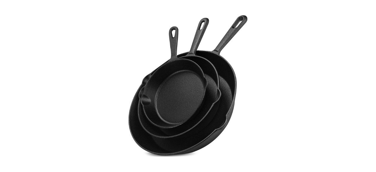 A set of three cast-iron pans without lids. They are each different sizes.