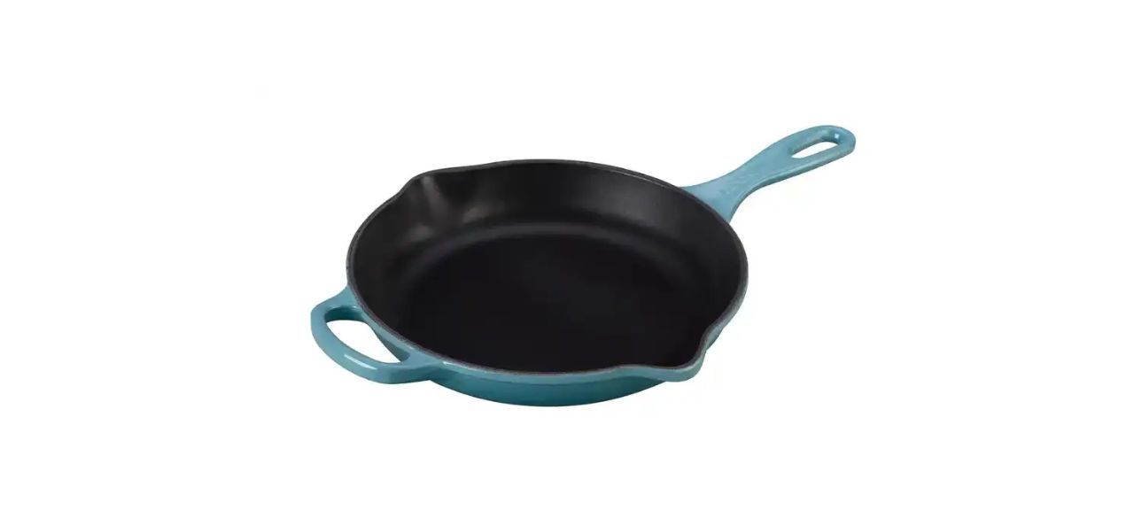 a cast iron skillet with a light blue enamel covering on the outside