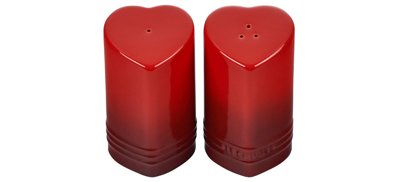 Red Le Creuset Stoneware Heart Shaped Salt & Pepper Shakers on white background
