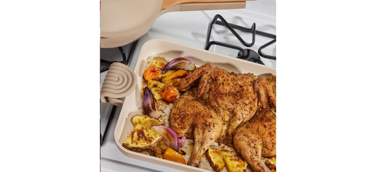 Beige Our Place Ovenware Set with cooked chicken and vegetables