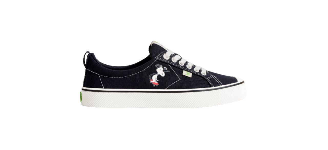 flat black canvas sneakers with an image of Snoopy on them