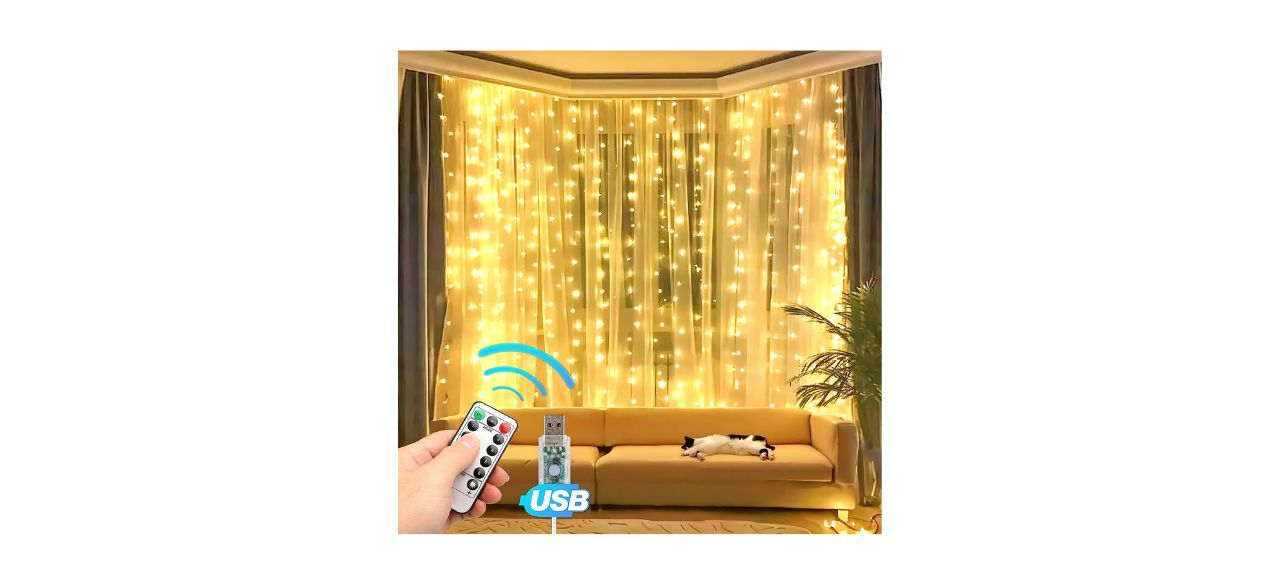 Eueasy 300 LED Curtain Lights with person pointing a remote at them, next to a USB cable