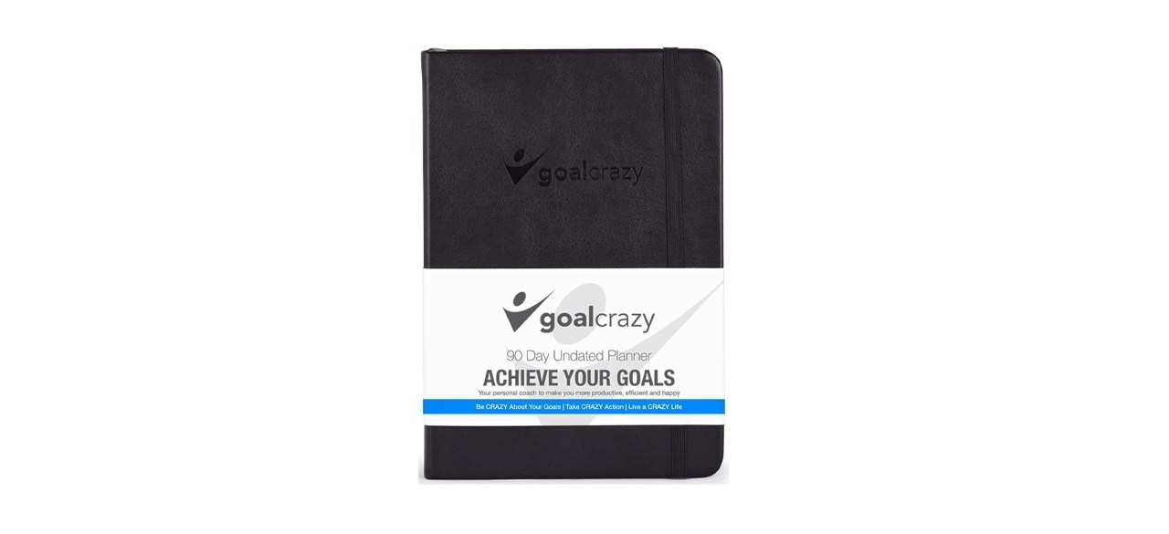 a black planner with the Goal Crazy logo on it