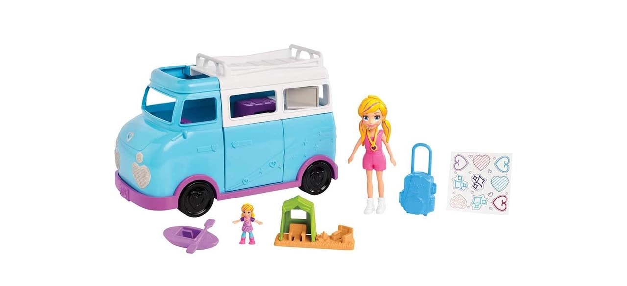 Polly Pocket Glamping Van on white background next to Polly Pocket doll and camping accessories