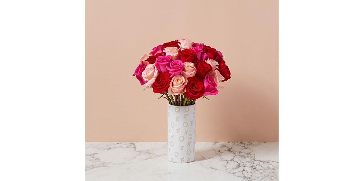 bunch of roses in a vase on a table