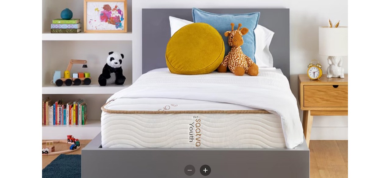 Saatva Youth Mattress with stuffed animal and throw pillows on top