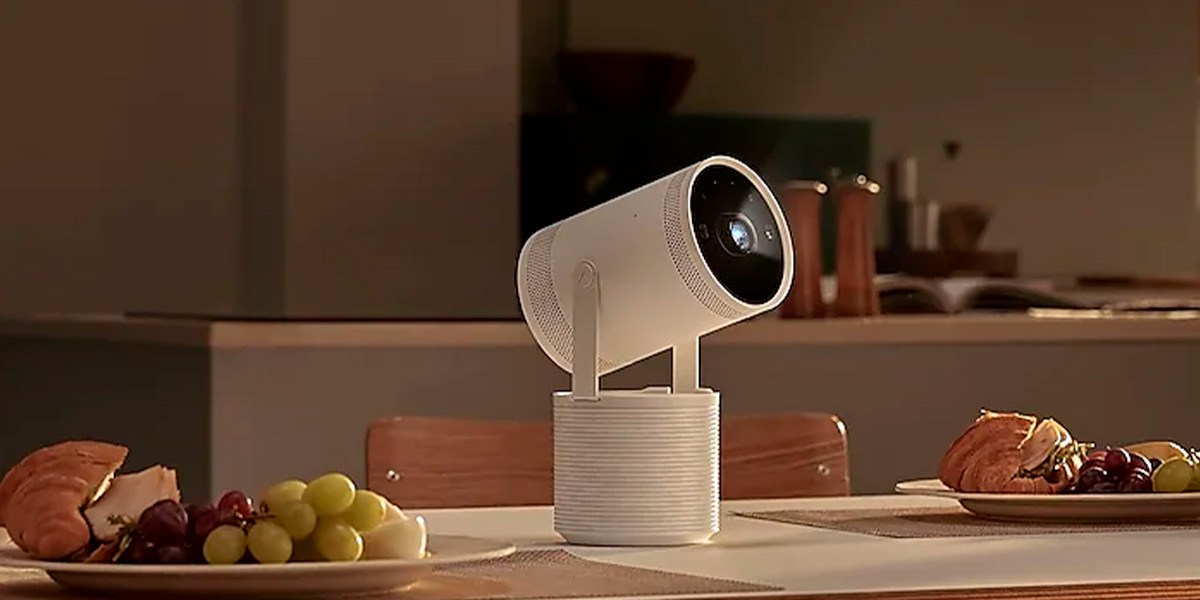 The Samsung Freestyle 2 projector on a dining room table with fruit