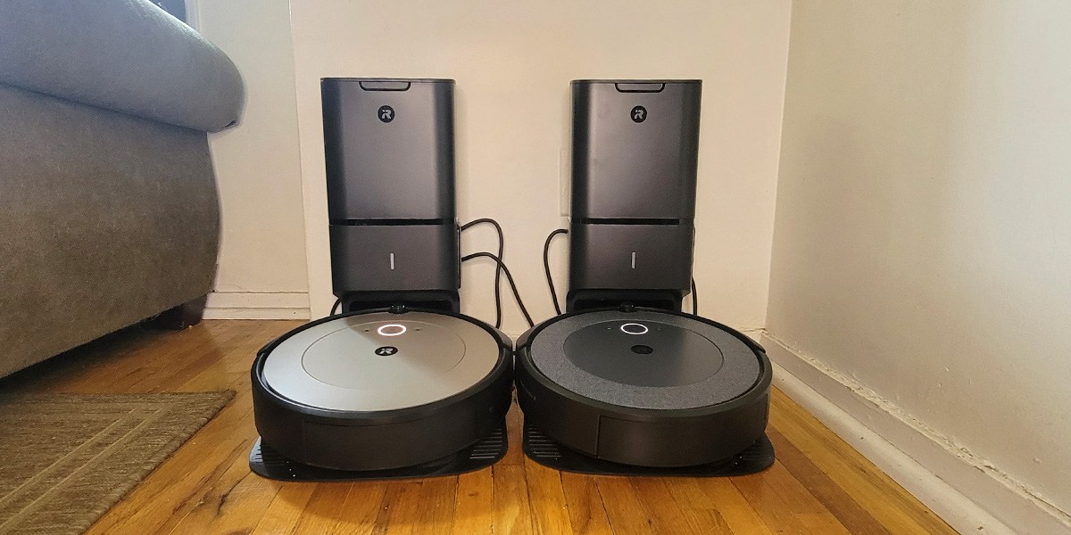 Two Roomba models side by side on charging bases 