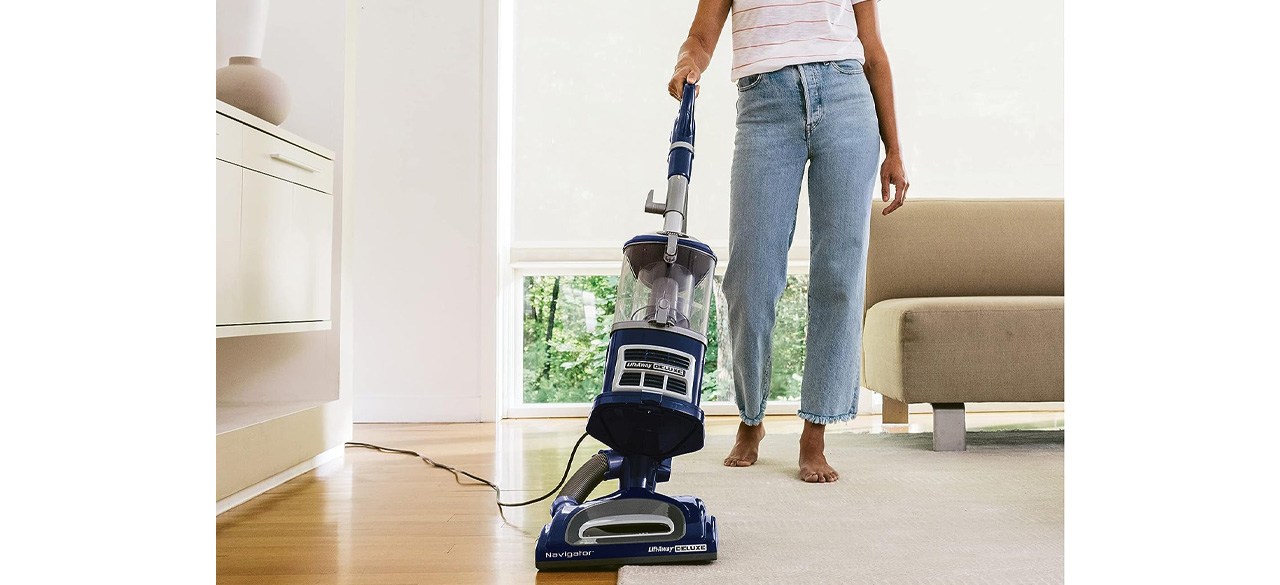 Person vacuuming with Shark NV360 Navigator Lift-Away Deluxe Upright Vacuum