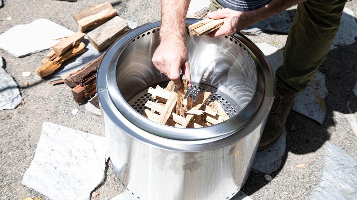 Person using Solo Stove outdoors