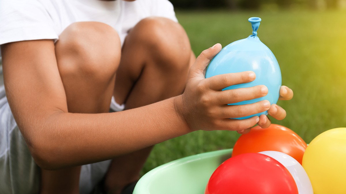 Child holding water balloon