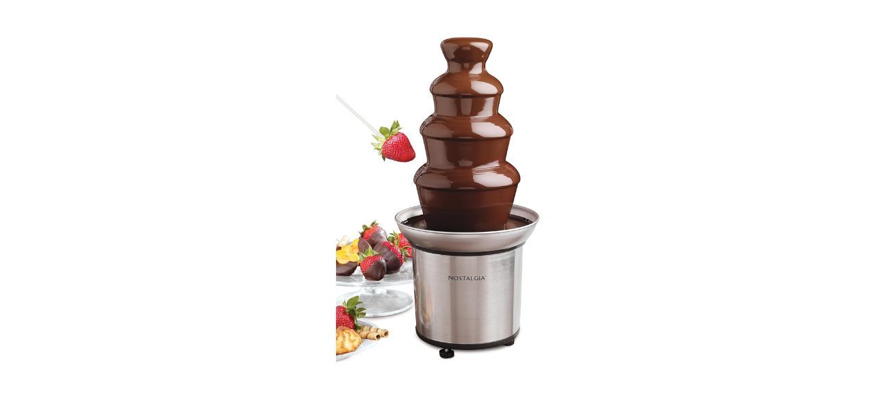 Chocolate fountain machine with chocolate and fruits