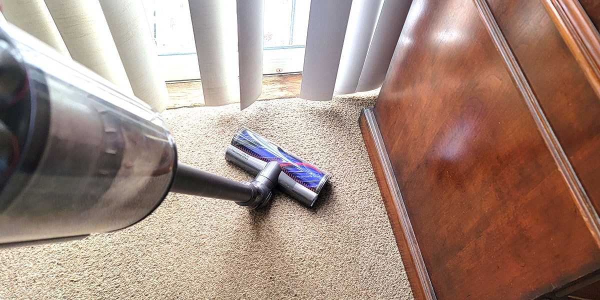 Dyson vacuum on carpeted flooring