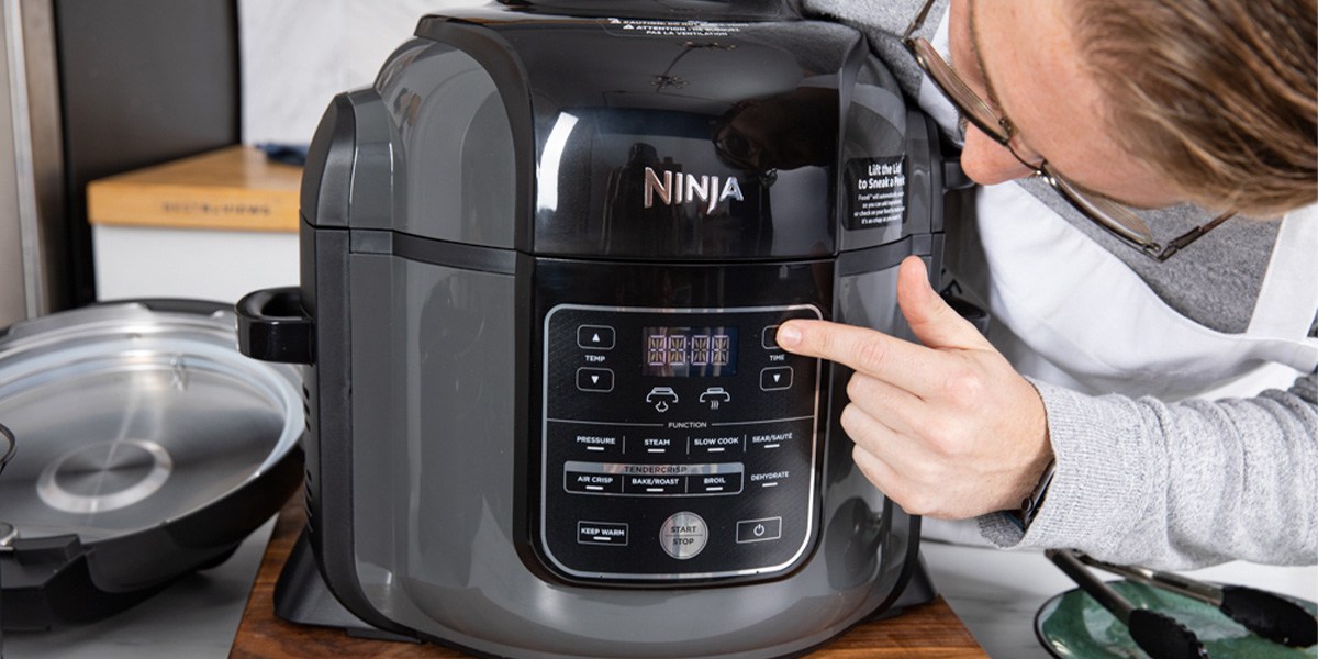 User pressing button on Ninja multicooker