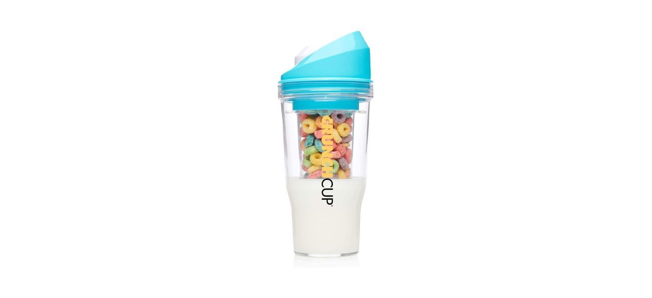 a cup with milk and cereal in it