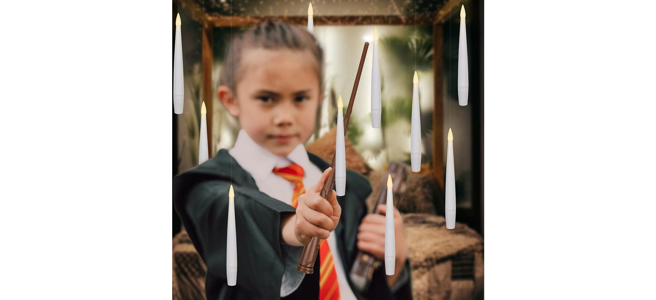 Boy in costume with floating candles and wand