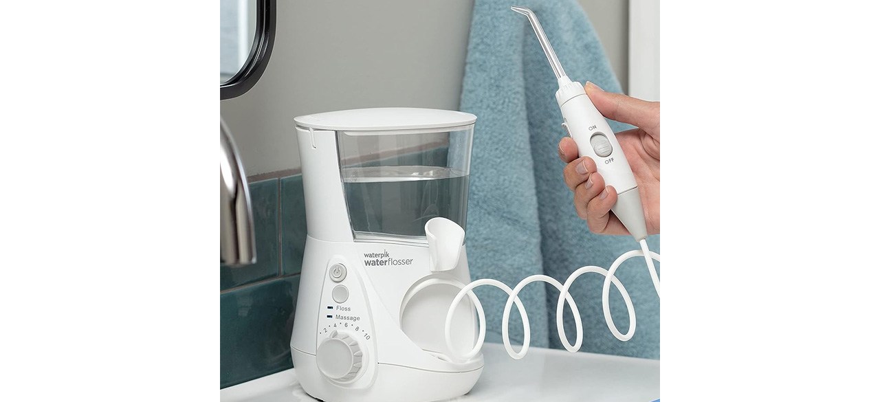 Hand holding Waterpik Aquarius Water Flosser