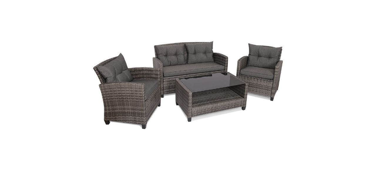 Two matching chairs and a loveseat made for outdoors with dark brown or black cushions and a woven exterior. There is also a matching table.