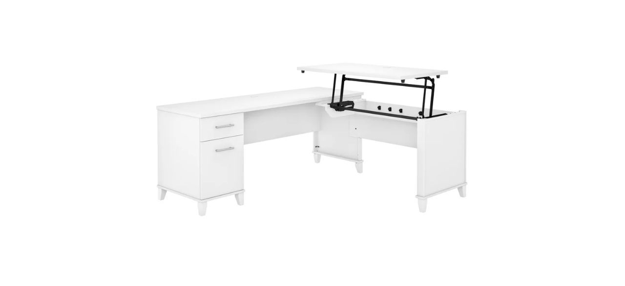 a white, L-shaped desk with 2 drawers on the left, and a lifted stand portion on the right