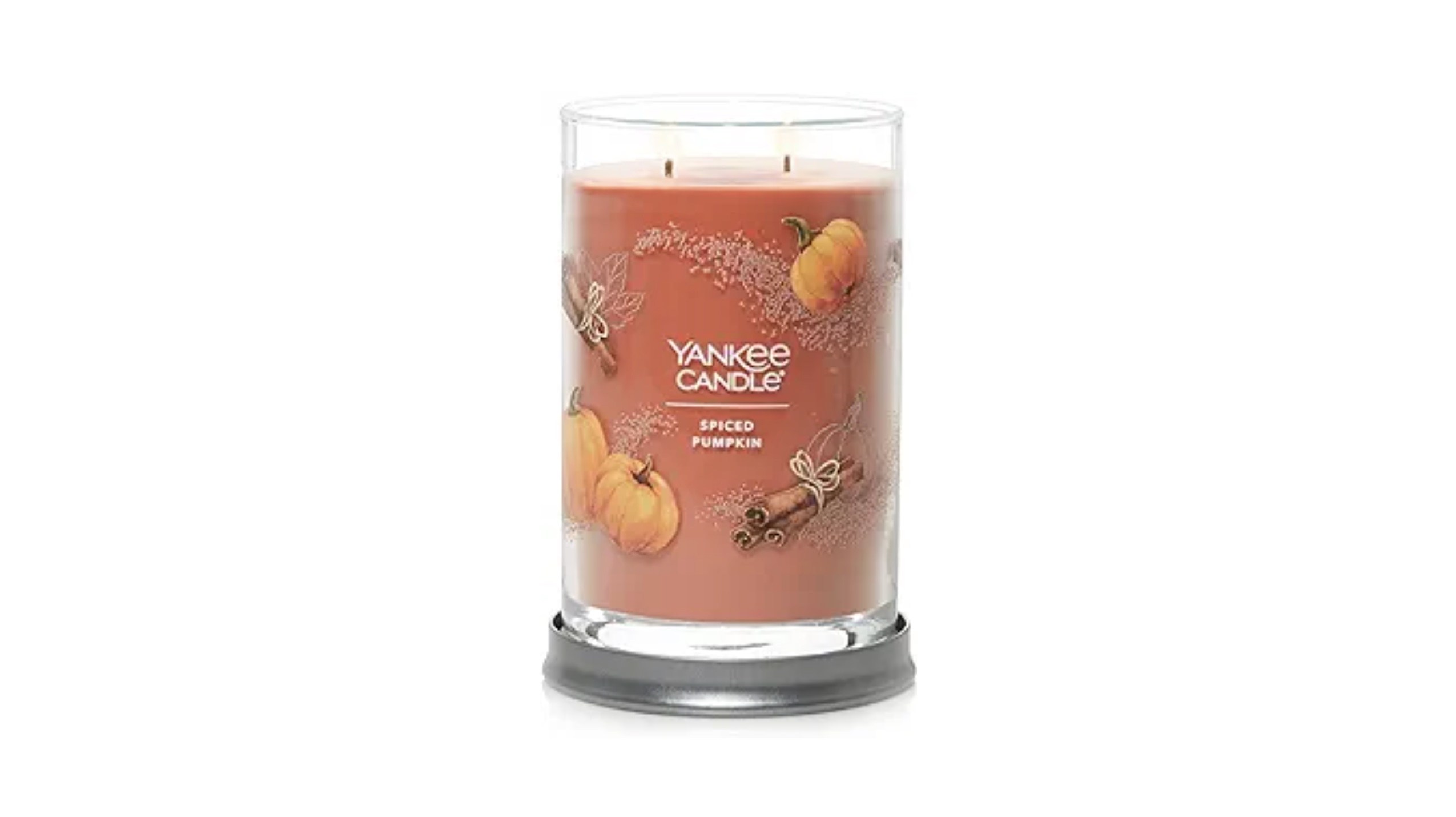 A tall pumpkin-spice scented candle (orange)